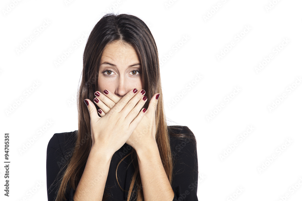 Close-up portrait of surprised attractive woman covering her mouth by the hands, over white background Close-up portrait of surprised attractive woman covering her mouth by the hands, over white background