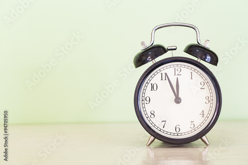 alarm clock on wood table, vintage style