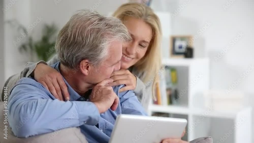 Mature couple using a tablet pc at home Mature couple using a tablet pc at home