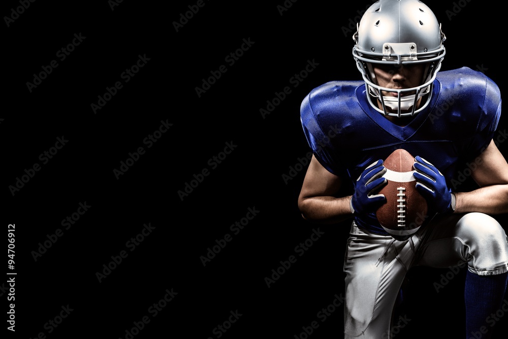 Composite image of american football player holding ball