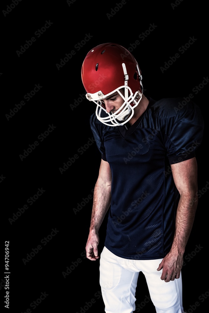Composite image of rugby player looking down