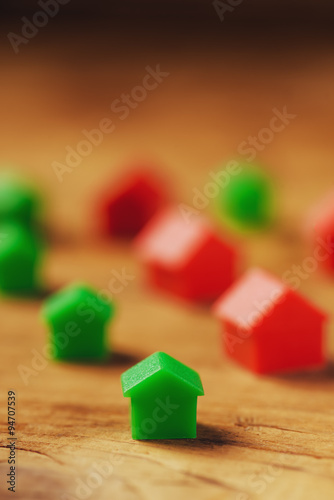 Plastic houses on wooden table
