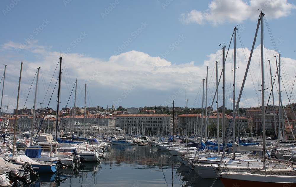 Motor boats and sailboats in harbor in Trieste, Italy