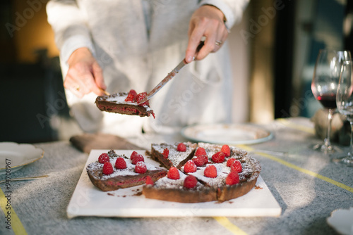 Delicious Chocolate Pie with Raspberries on top  powdered with icing sugar for Christmas dinner party