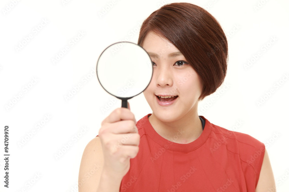Japanese woman with a magnifying glass Japanese woman with a magnifying glass