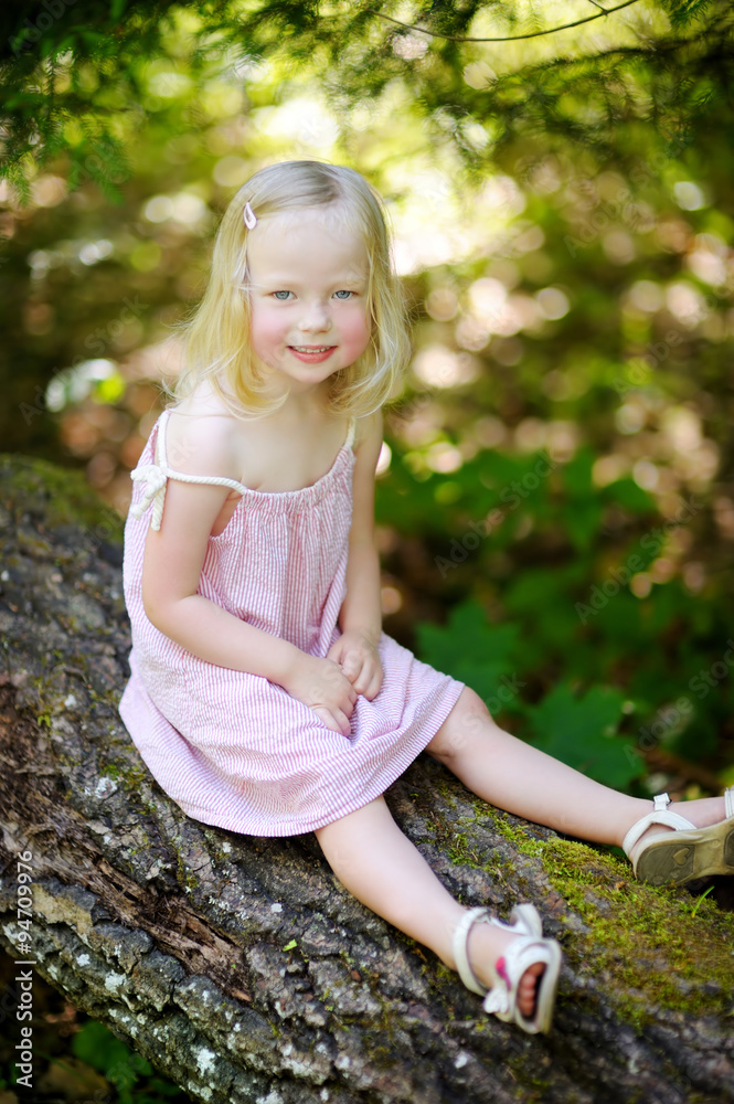 Adorable little girl hiking in the forest Adorable little girl hiking in the forest