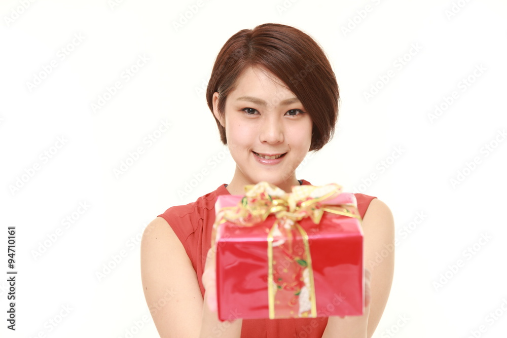 young Japanese woman offering a gift young Japanese woman offering a gift
