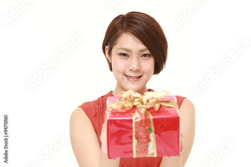  young Japanese woman offering a gift 