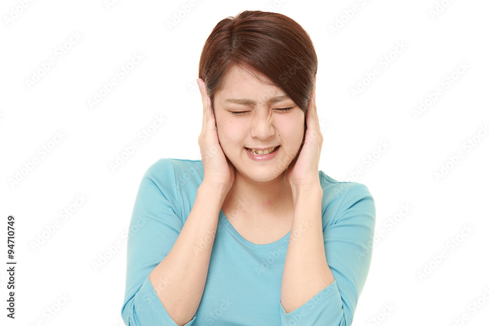 Young Japanese woman suffers from noise Young Japanese woman suffers from noise