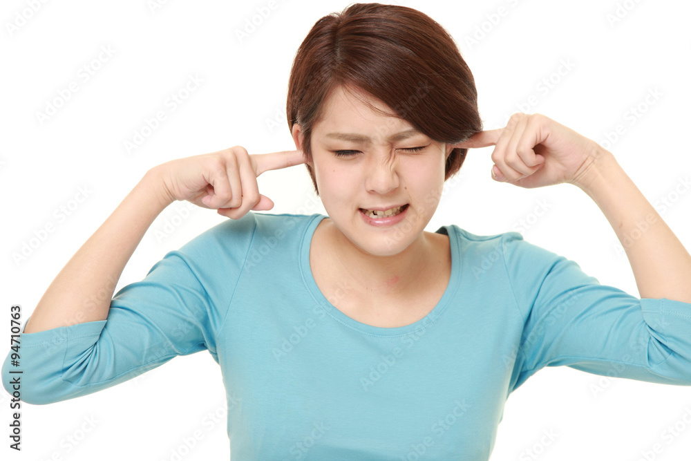 Young Japanese woman suffers from noise Young Japanese woman suffers from noise