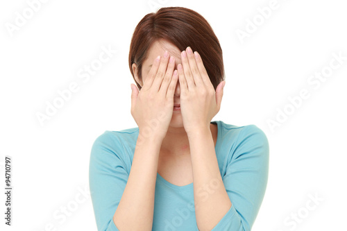 woman covering her face with hands 