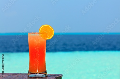 Fototapeta Naklejka Na Ścianę i Meble -  Glass of drink is on a beach table