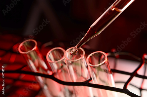 Pipette adding fluid to one of several test tubes