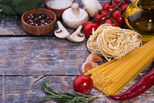 Ingredients for pasta on a wooden background