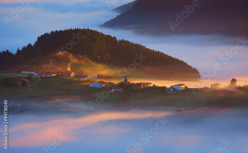 Barajuen village in Aramaio with morning fog photo