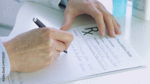 Doctors hand writting rx prescription 