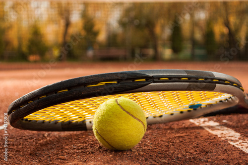 Tennis concept with racket and ball on clay court © Catalin Pop