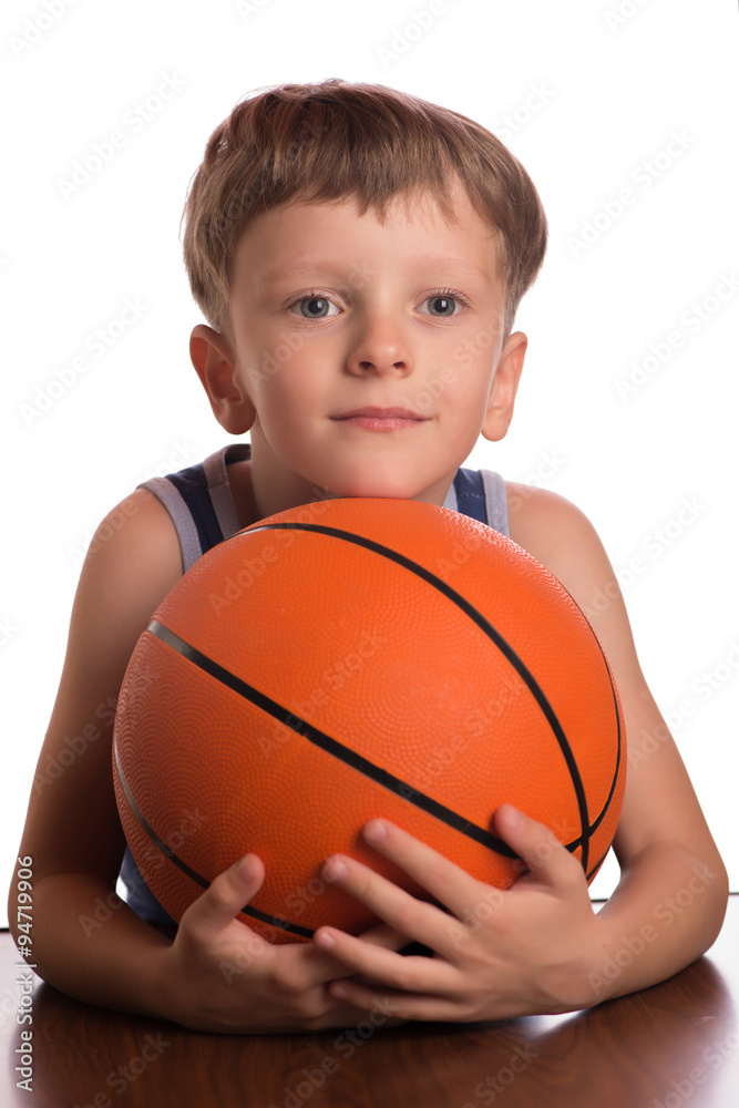 The boy pressing a basketball ball to a breast. The boy pressing a basketball ball to a breast.