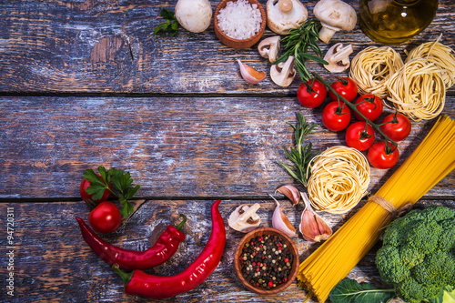 Pasta ingredients on a wooden background