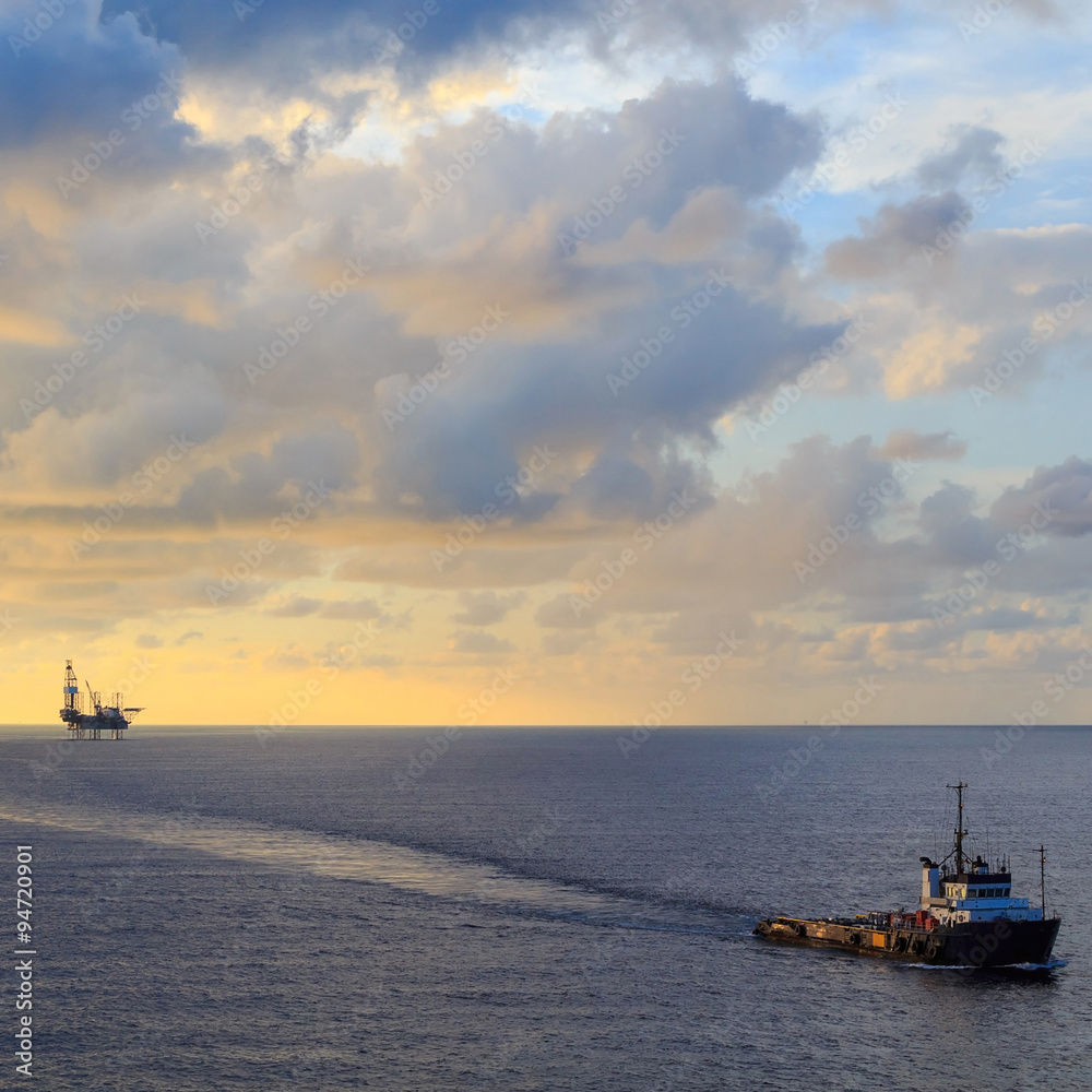 Fototapeta premium Offshore jack up drilling rig and supply boat