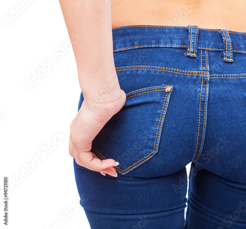 bottom of a young woman wearing blue jeans photo