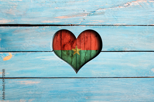 Love Burkina Faso. Heart and flag on a blue wooden board photo