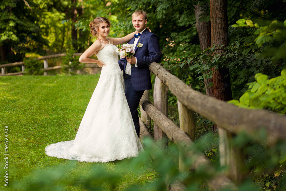 Couple standing near hedge in the forest