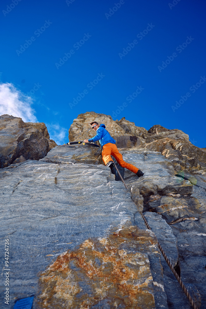 climber climbing up a cliff