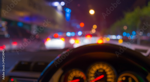 blur image of inside cars with bokeh lights from traffic jam on