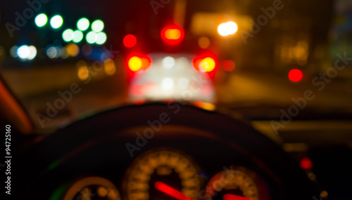 blur image of inside cars with bokeh lights from traffic jam on