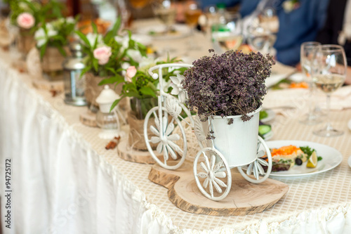 Wedding table with meal and decorative coach