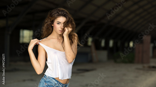 Sensual young woman portrait outdoors wearing short jeans and wh