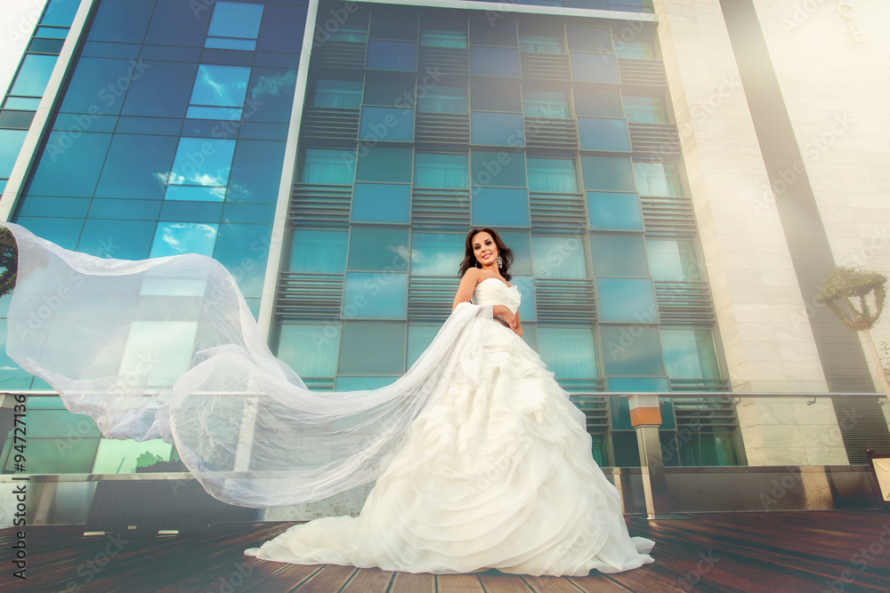 Woman bride in wedding dress and modern building Woman bride in wedding dress and modern building