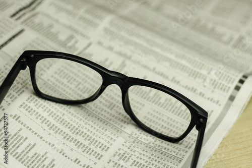 Glasses on newspaper. Macro view