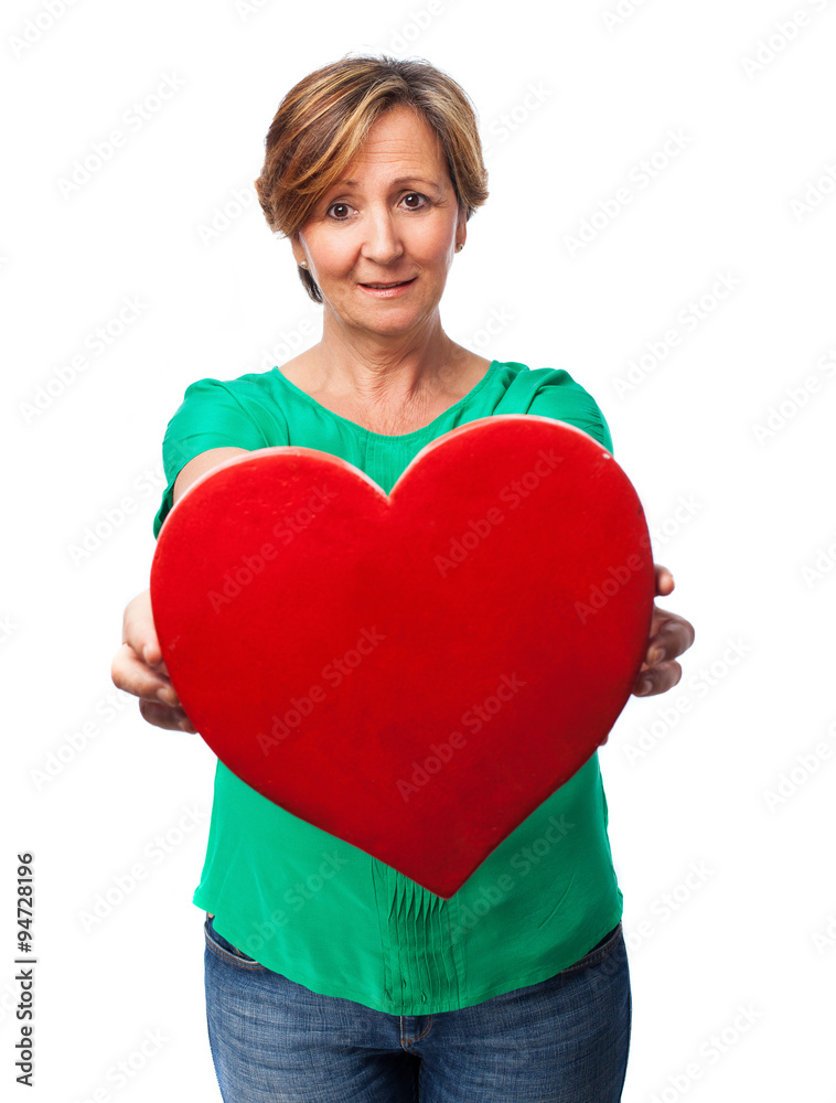 portrait of a mature woman holding a heart portrait of a mature woman holding a heart