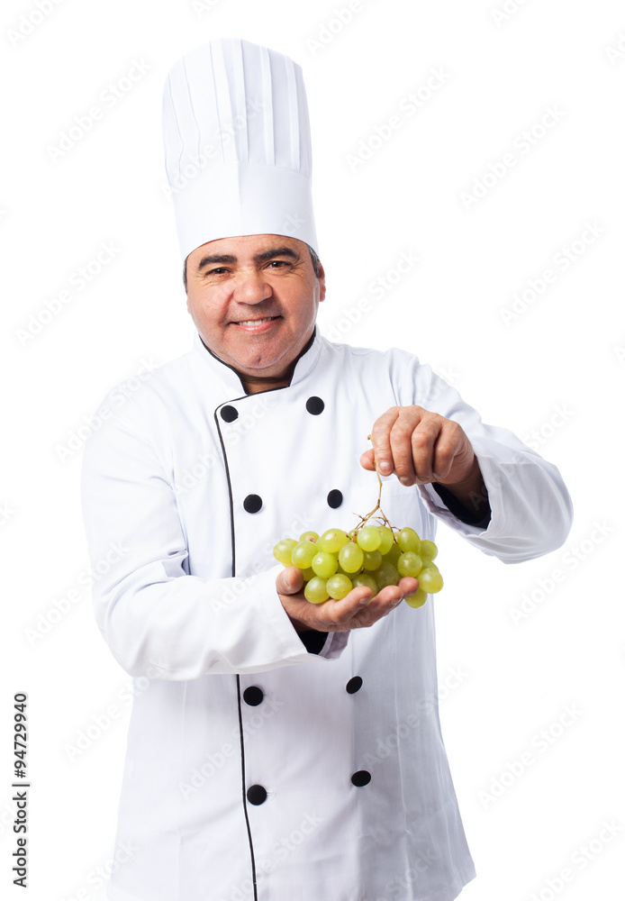portrait of a cook man holding a grapes bunch portrait of a cook man holding a grapes bunch