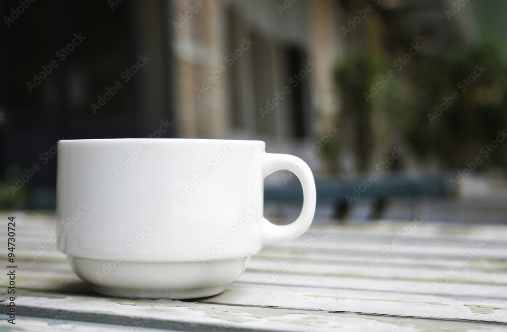 Coffee cup on wood table with blur background