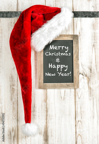 Red Santa hat and vintage chalkboard. Merry Christmas decoration