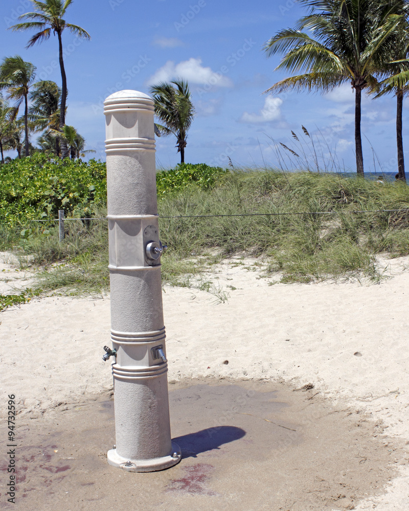 Outdoor Shower on a Fort Lauderdale Beach. One tall cement column that has one shower near the top, and two showers for the lower legs near on a Fort Lauderdale, Florida beach. Outdoor Shower on a Fort Lauderdale Beach. One tall cement column that has one shower near the top, and two showers for the lower legs near on a Fort Lauderdale, Florida beach.