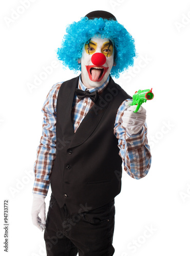 portrait of a clown with a gun toy photo