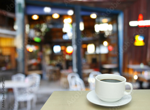 Blurred background : white cup of coffee and customer at restaur