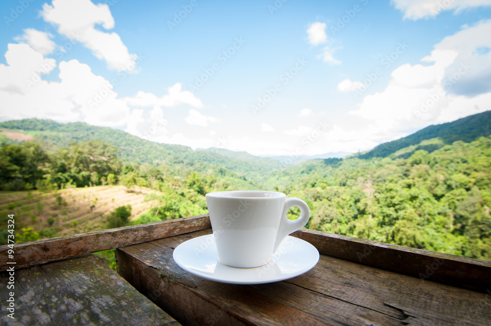coffee cup on wooden with blurry nature background coffee cup on wooden with blurry nature background