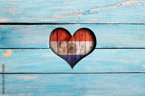 Love Paraguay. Heart and flag on a blue wooden board