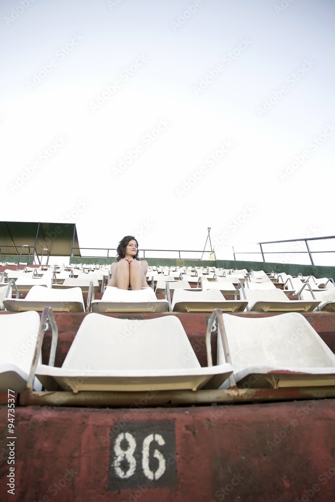 Retro girl sitting in stadium	