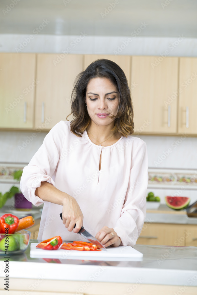 Beautiful Young woman cutting vegetables Beautiful Young woman cutting vegetables