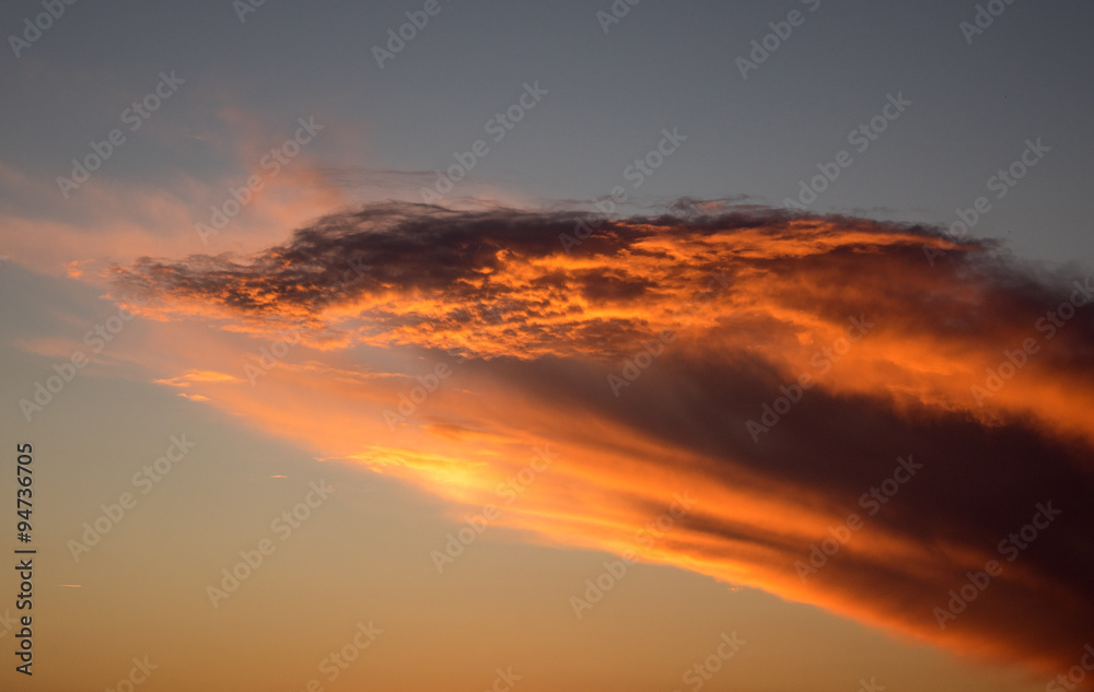 Brilliant red and orange sunlight on cloud