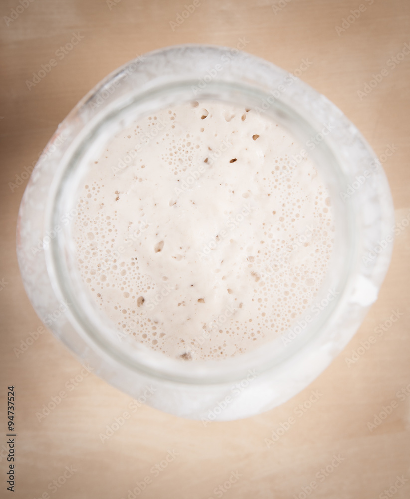 Sourdough natural yeast in large glass jar (top view) Sourdough natural yeast in large glass jar (top view)
