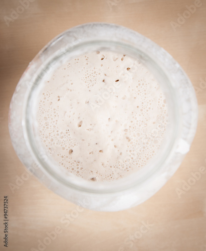Sourdough natural yeast in large glass jar (top view)
