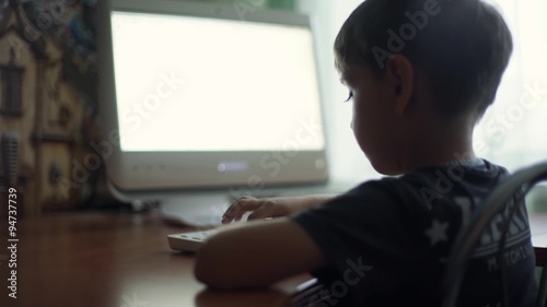 little boy using computer, early education