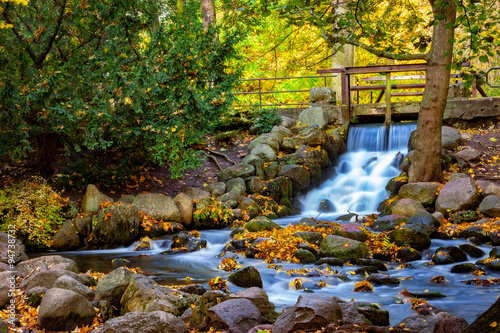 Fototapeta Naklejka Na Ścianę i Meble -  Waterfall in the forest on autumn scenery. Oliwa, Poland.